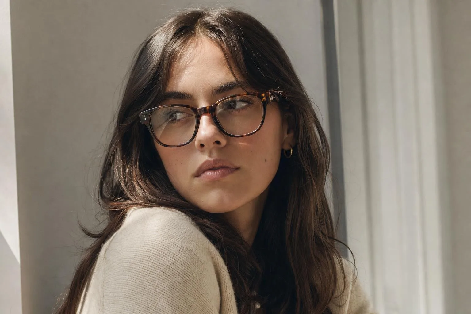 A row of designer eyewear frames on a clean neutral surface